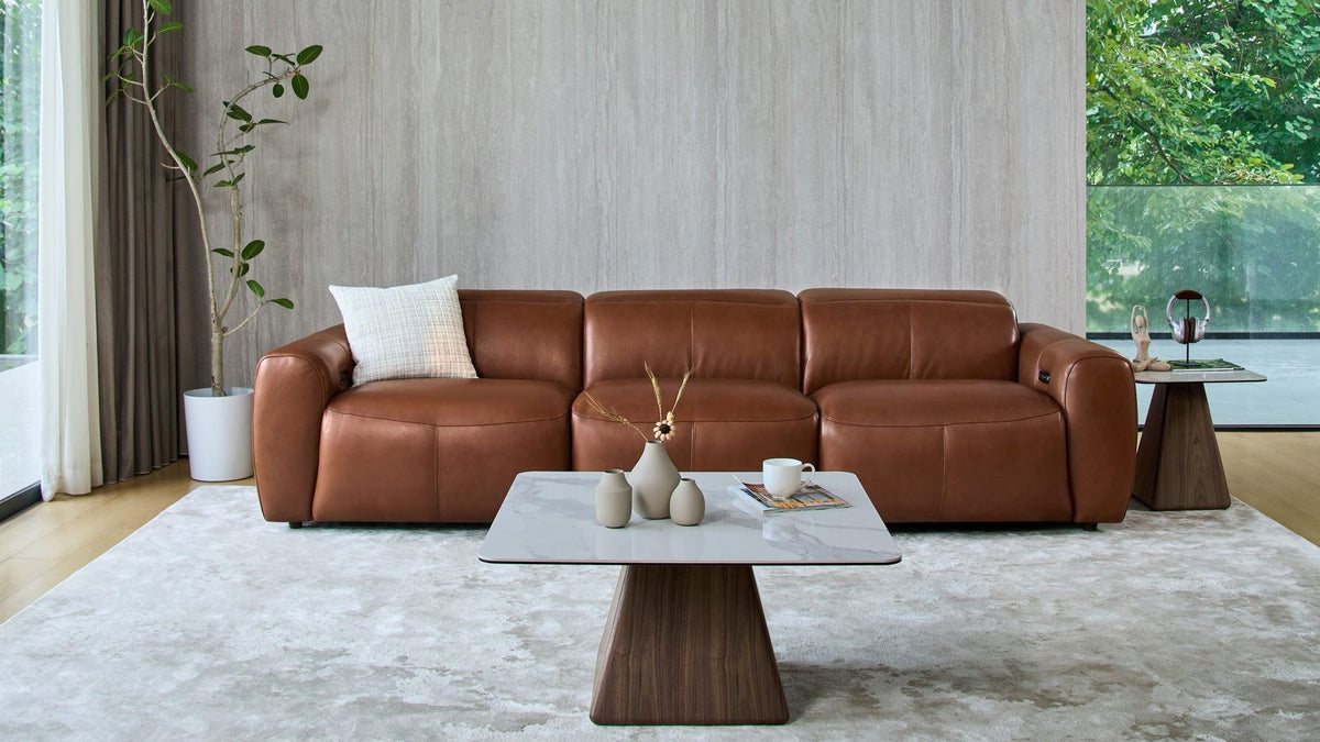 Cambridge 3 seat sofa in tan leather with a stone-top coffee table, a pet-friendly lounge setting
