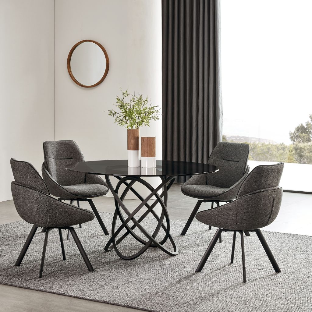 Boma Dining Table with a round tempered glass top and satin black metalwork