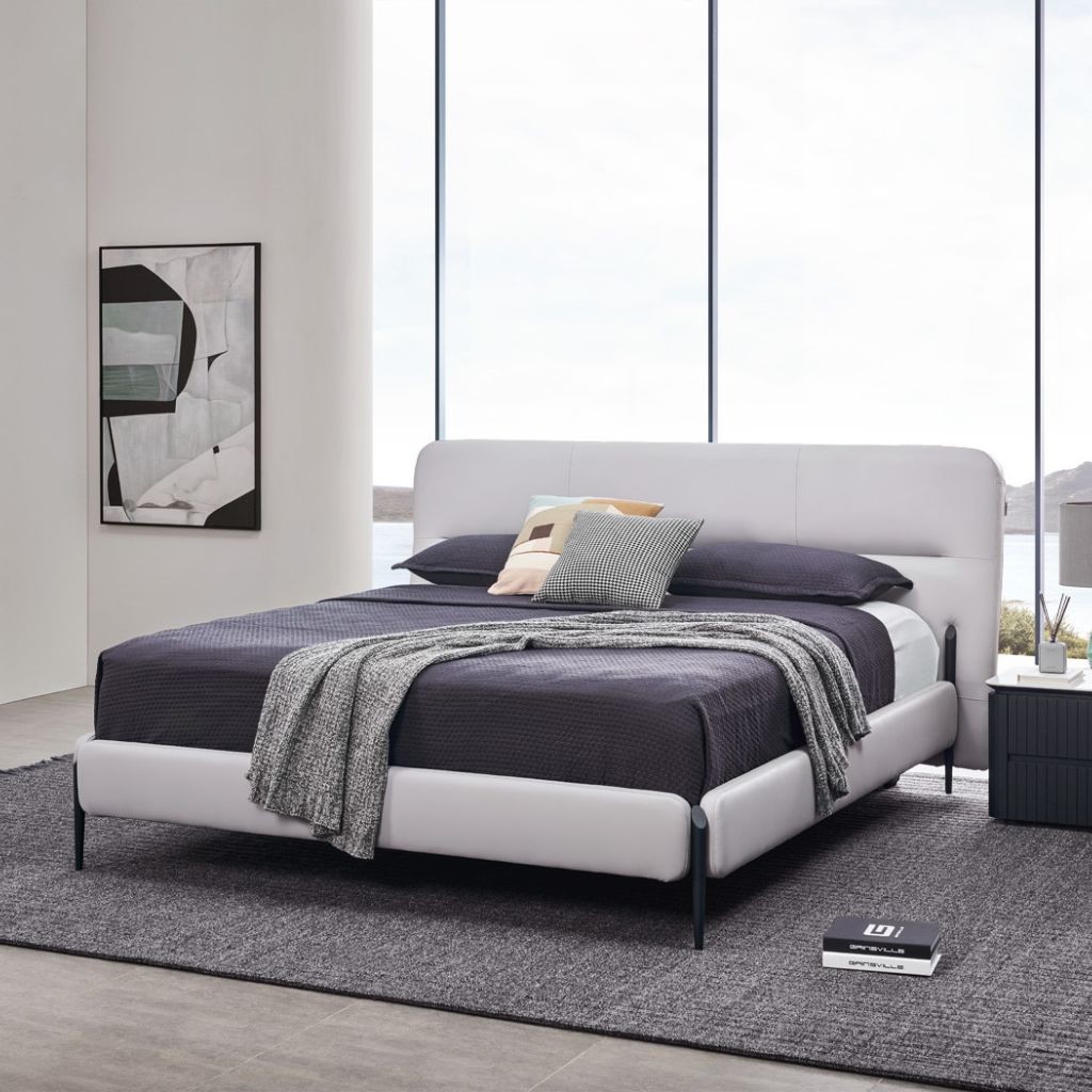 Odessa Bed with a minimalist angled headboard and satin black metal legs in a modern bedroom
