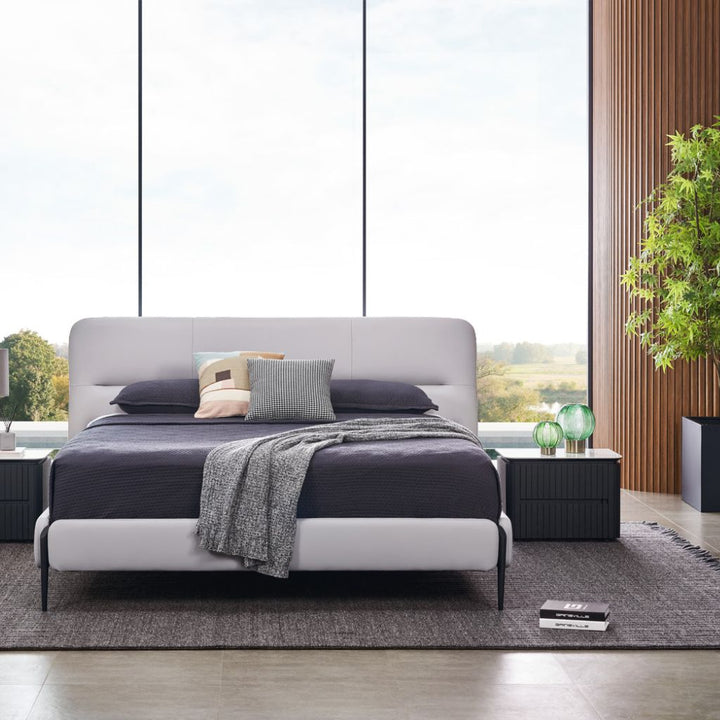 Odessa Bed side profile showing the raised frame on satin black legs