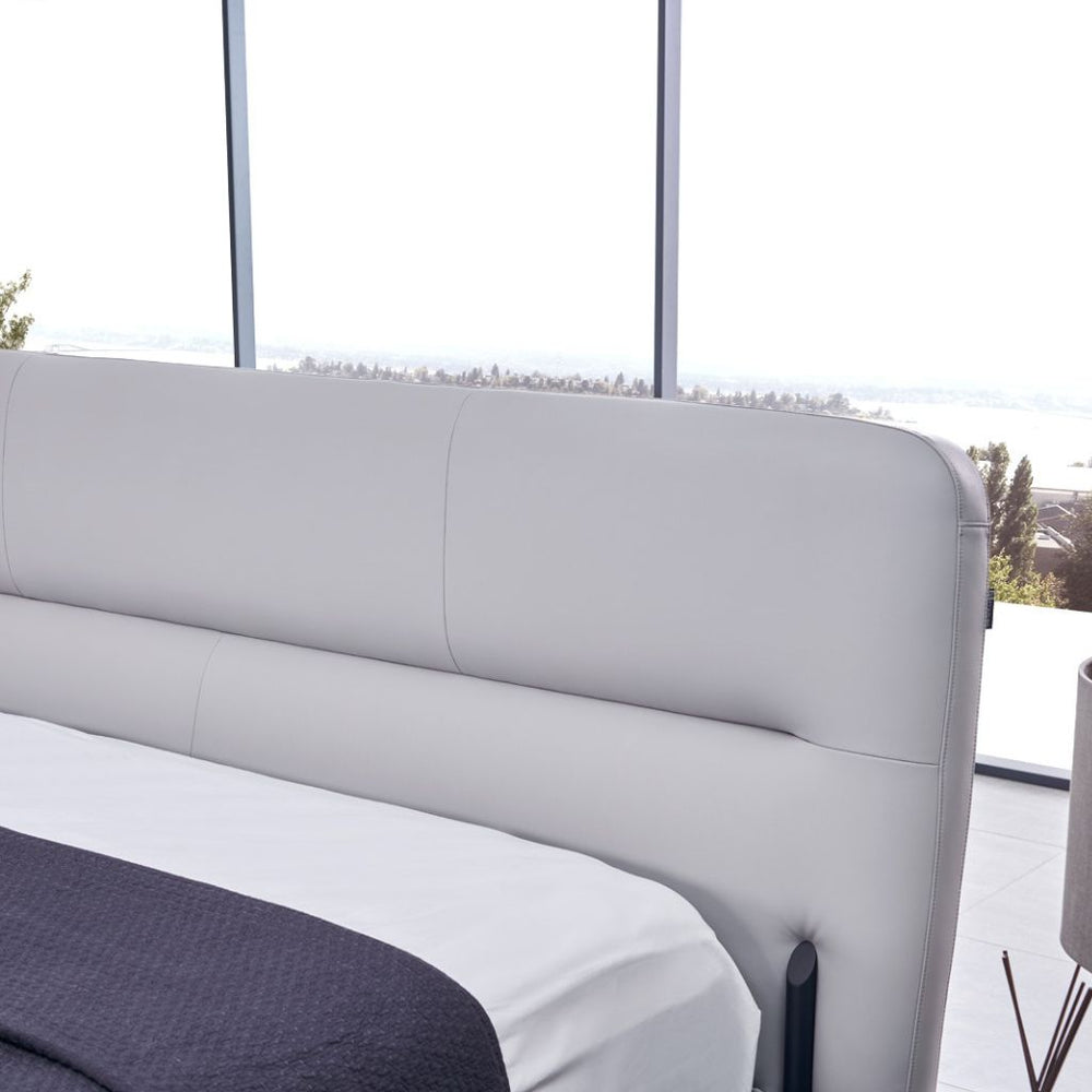 Odessa Bed front view showing the angled backrest and thin black legs