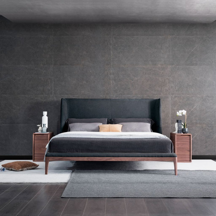 Olivia Bed with a raised American Walnut timber frame and sofa-style headboard in a modern bedroom