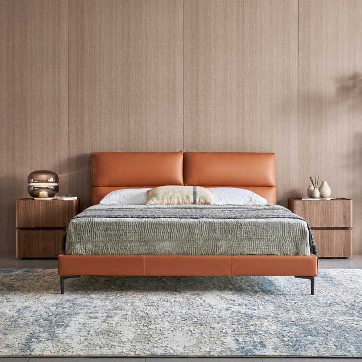 Winchester Bed with a cushioned headboard and slim satin black legs in a modern bedroom