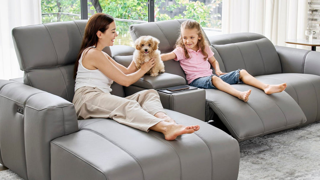 Mother and daughter with their dog on the Bailey Chaise Sofa in grey leather
