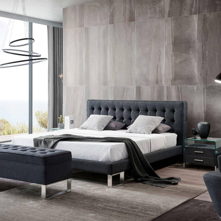 Vienna Bed in fabric with a tufted padded headboard and stainless steel legs
