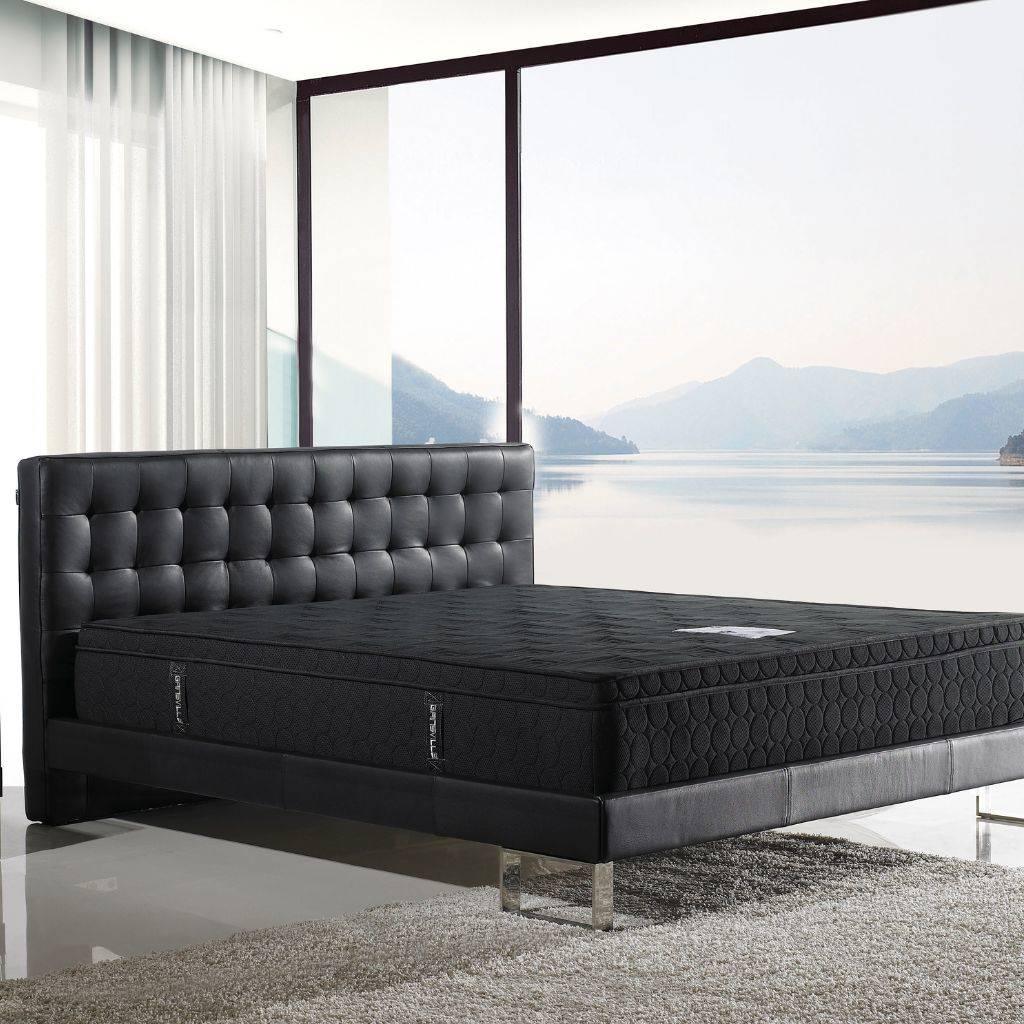 Vienna Bed in leather showing the tufted headboard and steel feature legs