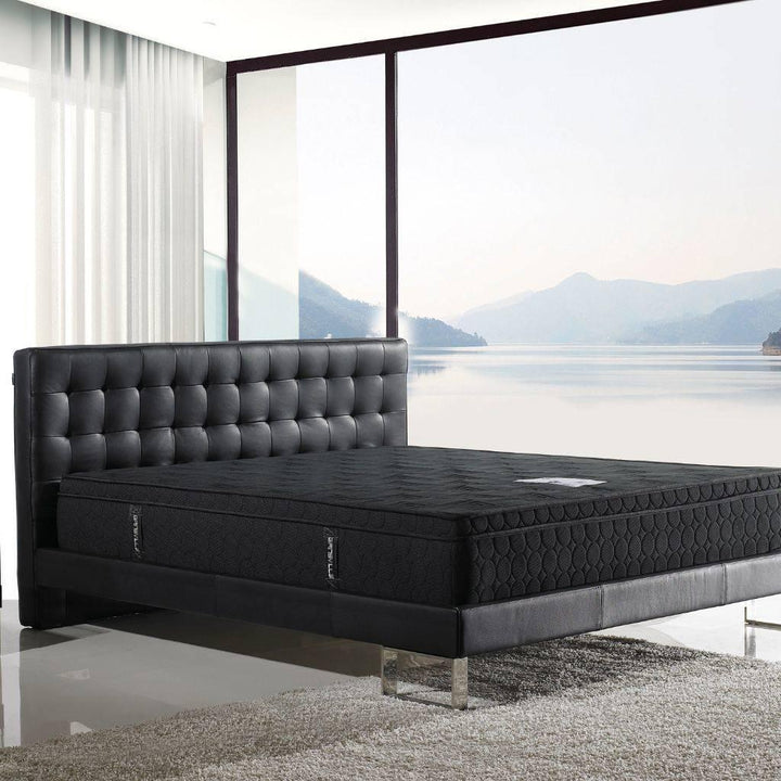 Vienna Bed in leather showing the tufted headboard and steel feature legs
