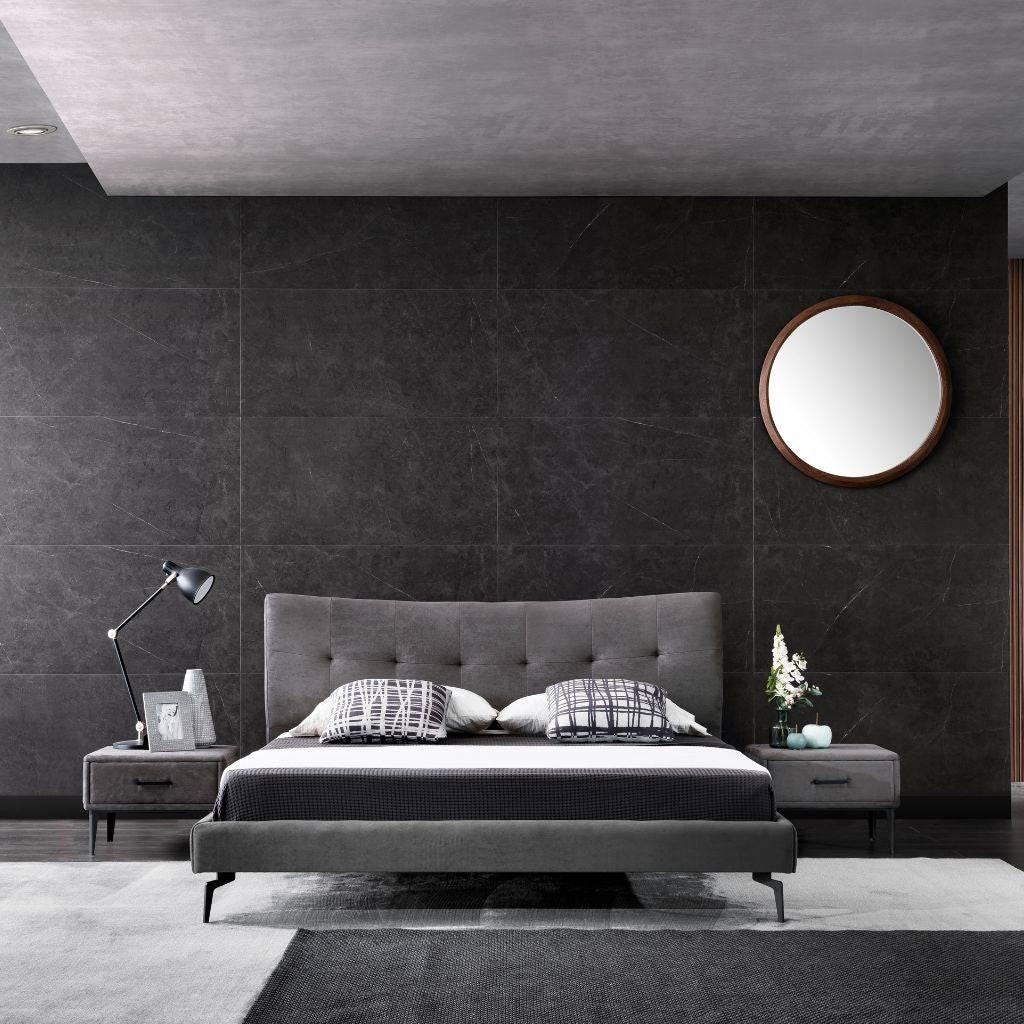 Vira Bed with a tufted upholstered headboard and satin black feet in a modern bedroom